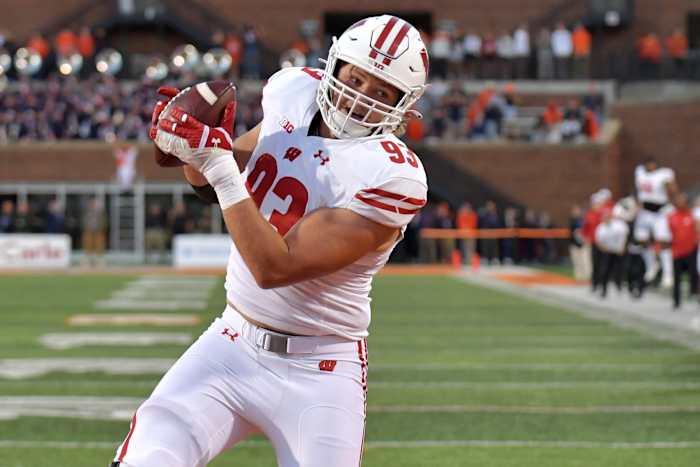 Oct 21, 2023; Champaign, Illinois, USA; Wisconsin Badgers defensive end Isaac Townsend (93) catches a touchdown during the second half against the Illinois Fighting Illini at Memorial Stadium. Mandatory Credit: Ron Johnson-USA TODAY Sports